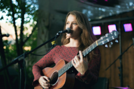 women with guitar on stage in the evening outdoor